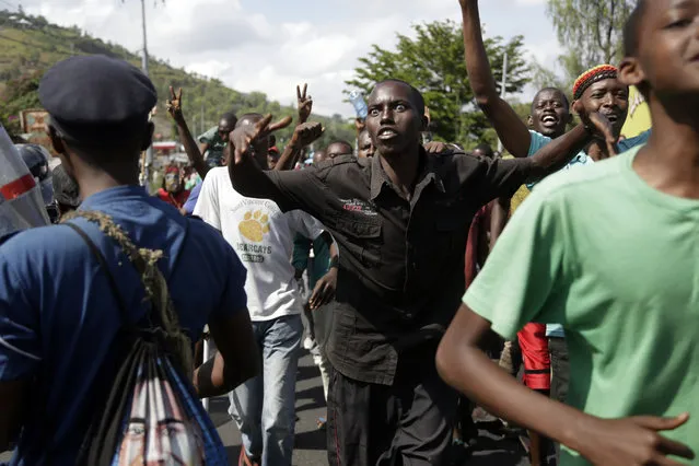 Protesters gesture as they march through the Musaga district of Bujumbura, in Burundi, Monday, May 11, 2015. (Photo by Jerome Delay/AP Photo)