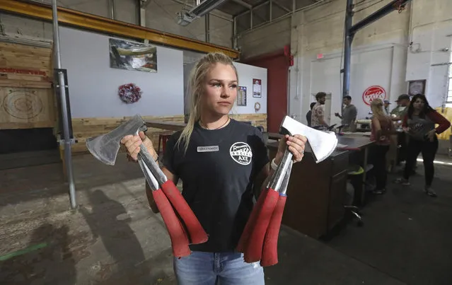Axe-throwing coach Kennedy Howard holds axes at Social Axe Throwing Wednesday, May 1, 2019, in Salt Lake City. The Utah Department of Alcoholic Beverage Control announced Tuesday, April 30, 2019, that beer will not be allowed at the Salt Lake City karaoke business or an Ogden axe-throwing venue because neither fits the 14 definitions of a “recreational amenity”, under a new law passed by Utah's Republican-controlled legislature during the yearly session that ended in March. (Photo by Rick Bowmer/AP Photo)