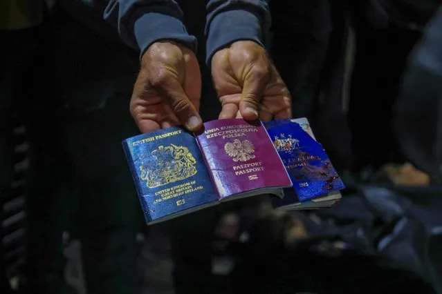 A man displays British, Polish, and Australian passports next to the bodies of World Central Kitchen workers at Al-Aqsa Hospital in Deir al-Balah, Gaza Strip, on April 1, 2024, amid the ongoing battles between Israel and the Palestinian militant group Hamas. World Central Kitchen, a US-based charity, said on April 2 it was pausing its Gaza aid operations after seven of its staff were killed in a “targeted Israeli strike” as they unloaded desperately needed food aid delivered by sea from Cyprus. (Photo by AFP Photo)