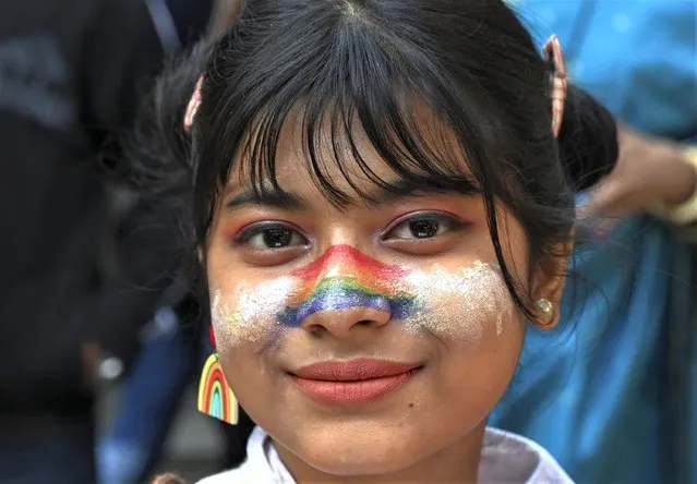 A participant has rainbow colors smeared on the face as members of the LGBTQ community and their supporters march demanding equal marriage rights in New Delhi, India, Sunday, January 8 2023. The government is yet to legalize same-s*x marriages in the country even though the Supreme Court in 2018 struck down a colonial-era law that made gay s*x punishable by up to 10 years in prison. (Photo by AP Photo/Stringer)