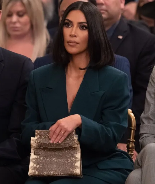 Kim Kardashian listens as US President Donald Trump speaks about second chance hiring and criminal justice reform in the East Room of the White House in Washington, DC, June 13, 2019. (Photo by Saul Loeb/AFP Photo)