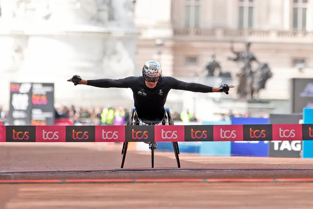 Marcel Hug of Switzerland crosses the finish line to win the men's wheelchair race at the London Marathon in London, Sunday, April 21, 2024. (Photo by David Cliff/AP Photo)