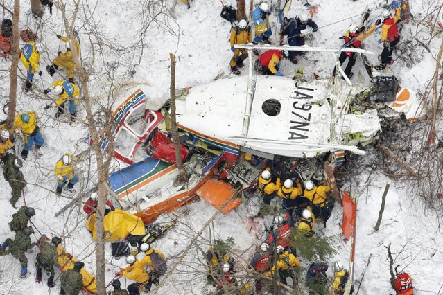 Rescuers work near the helicopter crashed in mountains in Nagano prefecture, central Japan Monday, March 6, 2017.  Japanese authorities confirmed Monday that all nine people aboard a rescue helicopter that crashed in snow-covered mountains in central Japan have been pronounced dead. (Photo by Yohei Kanasashi/Kyodo News via AP Photo)