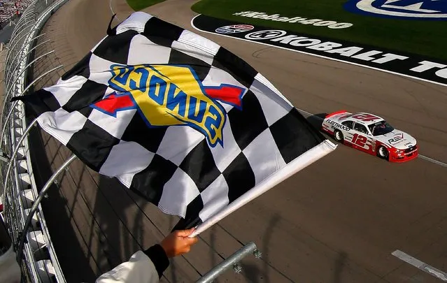 Joey Logano, driver of the #12 REV Ford, takes the checkered flag to win the NASCAR XFINITY Series Boyd Gaming 300 at Las Vegas Motor Speedway on March 11, 2017 in Las Vegas, Nevada. (Photo by Sean Gardner/Getty Images)