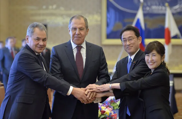 Russian Defence Minister Sergei Shoigu (L) and Foreign Minister Sergei Lavrov (2nd L) shake hands with Japanese Foreign Minister Fumio Kishida (2nd R) and Defense Minister Tomomi Inada at the start of their Japan-Russia foreign and defense ministers meeting called “two-plus two” at Iikura guest house in Tokyo, Japan March 20, 2017. (Photo by David Mareuil/Reuters)