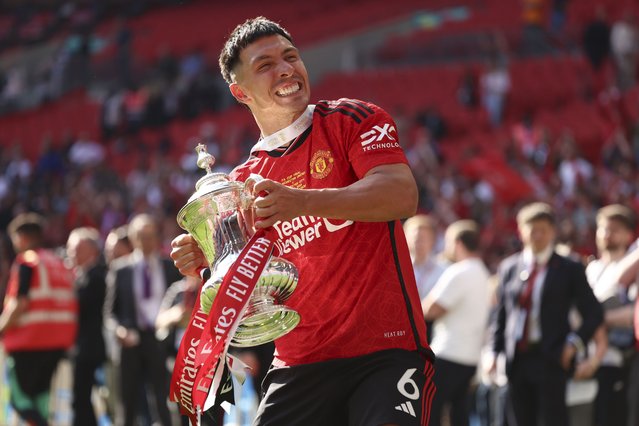 Manchester United's Lisandro Martinez celebrates with the trophy after winning the English FA Cup final soccer match between Manchester City and Manchester United at Wembley Stadium in London, Saturday, May 25, 2024. (Photo by Ian Walton/AP Photo)