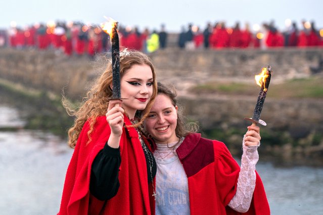 Students from the University of St Andrews in Scotland, wearing their traditional red gowns, take part on Tuesday, April 30, 2024 in The Gaudie, a procession through the town and down to the pier. The annual Gaudie takes place every 30 April to commemorate former student John Honey, who in 1800 rescued members of the crew of the Janet of Macduff which had run aground off the East Sands. (Photo by Jane Barlow/PA Images via Getty Images)
