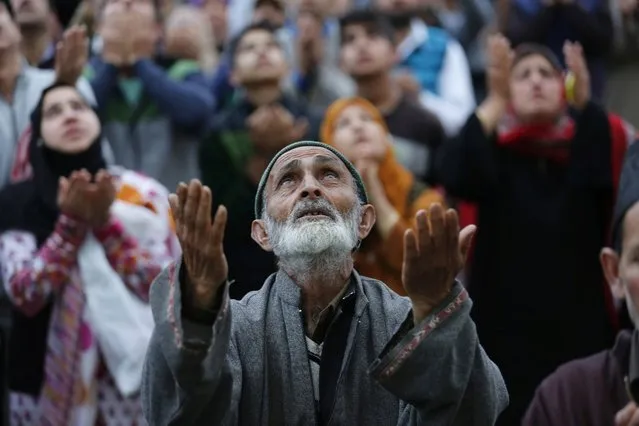People pray as the head priest (not  pictured) displays a holy relic at the famous Hazratbal shrine on the occasion of Me'raj-ul-Alam on the outskirts of Srinagar, the summer capital of Indian Kashmir, 05 May 2016. Hundreds of Kashmiri Muslims gathered at the Hazratbal shrine, which houses a relic believed to be made of hair from the beard of the Islamic Prophet Muhammad. (Photo by Farooq Khan/EPA)