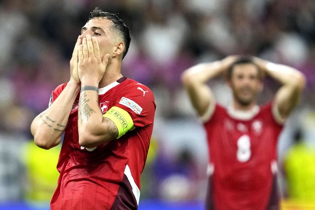 Switzerland's Granit Xhaka holds his face after missing a chance to score during a Group A match between Switzerland and Germany at the Euro 2024 soccer tournament in Frankfurt, Germany, Sunday, June 23, 2024. (Photo by Darko Vojinovic/AP Photo)