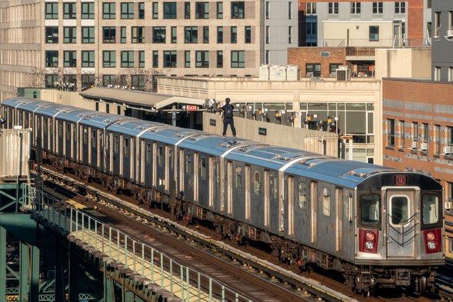 A person is subway surfing on the 5 train on March 16, 2023 in the Bronx borough of New York City. The reported numbers of people riding outside of subway trains jumped from 199 in 2020 to 928 in 2022, an increase of 366% MTA (Metropolitan Transportation Authority) data shows. (Photo by David Dee Delgado/Getty Images)