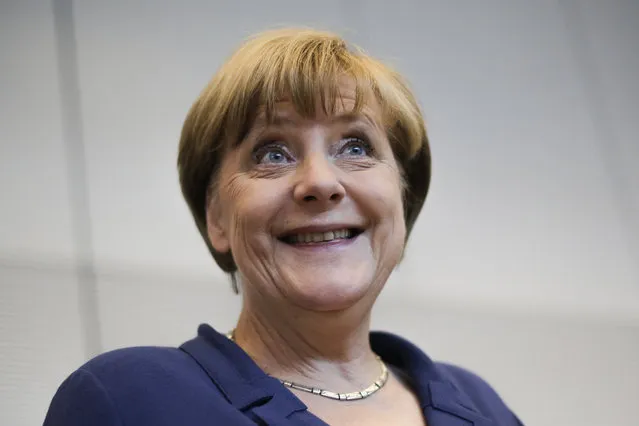 German Chancellor Angela Merkel smiles as she arrives for a special meeting of the Christian Democratic Union (CDU) party faction on the eve of a special session of the parliament Bundestag about negotiations with Greece for a new bailout in Berlin, Germany, Thursday, July 16, 2015. (Photo by Markus Schreiber/AP Photo)