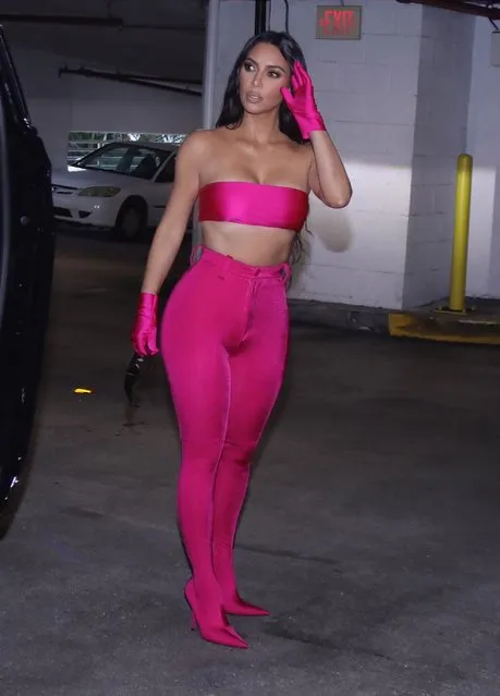 Kim Kardashian looks sensational in hot pink as she heads for a night out after the launch of her Skims Swim pop-up shop in Miami on March 19, 2022. (Photo by The Mega Agency)