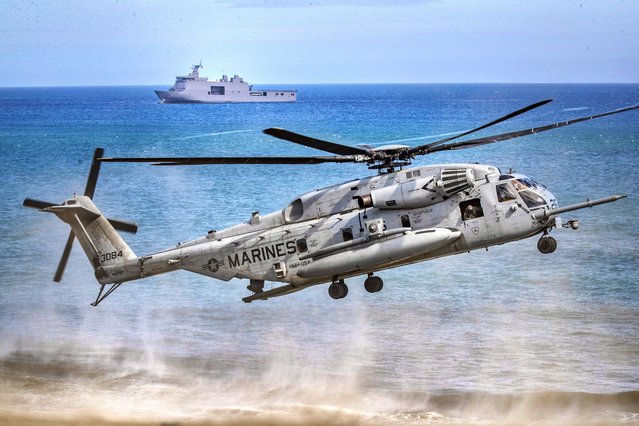 A US Marine CH53 helicopter takes off as US and Philippine marines take part in a joint amphibious assault exercise as part of the annual 'Balikatan' (shoulder-to-shoulder) US-Philippines war exercises, off the waters of South China Sea on March 31, 2022 in Claveria, Cagayan province, Philippines. This year’s exercise, which the two sides are billing as the largest ever with nearly 9,000 troops taking part, also comes at a time of increasing geopolitical uncertainty amid the Russia-Ukraine war and China’s continuing assertiveness in disputed territories of the South China Sea, including in areas claimed by the Philippines. (Photo by Ezra Acayan/Getty Images)