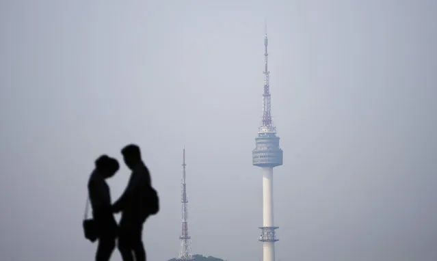 A couple is silhouetted against the backdrop of N Seoul Tower, commonly known as Namsan Tower, in Seoul May 13, 2014. (Photo by Kim Hong-Ji/Reuters)