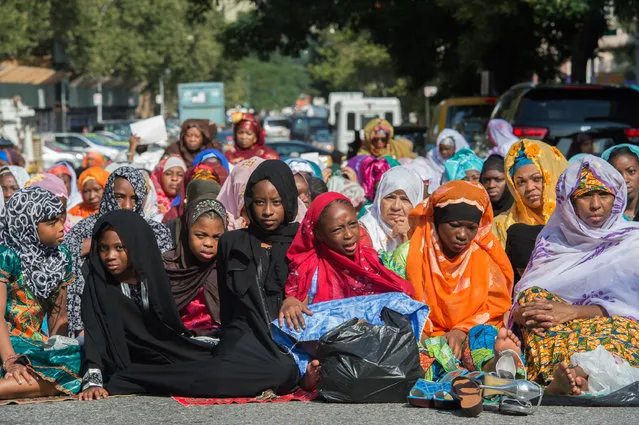 Women and girls in New York's East Harlem neighborhood take part in the traditional annual prayer commemorating the end of Ramadan in front of the Masjid Aqsa-Salam mosque on  Friday, July 17, 2015. The Islamic Eid Al-Fitr holiday celebrates the conclusion of 30 days of dawn-to-sunset fasting. (Photo by Bryan R. Smith/AP Photo)