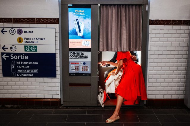 A couple poses for a joint photograph in a photo booth (photomaton) at a metro station in Paris on July 24, 2024. (Photo by Dimitar Dilkoff/AFP Photo)