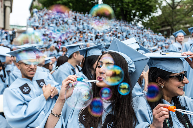 Students blow bubbles during a commencement ceremony at Columbia University in New York, USA on May 19, 2016. (Photo by Xinhua/Barcroft Images)