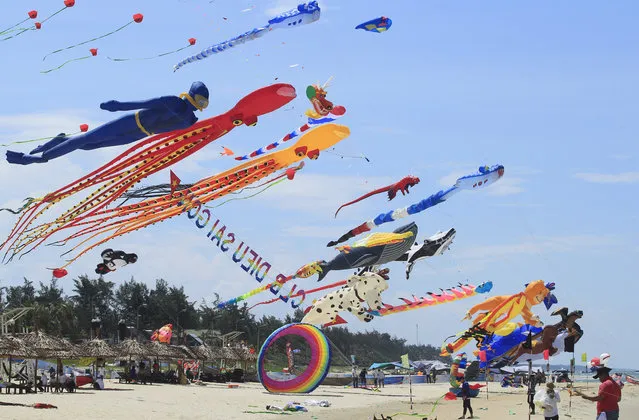 In this Sunday, June 11, 2017, photo, colorful kites are flown in the sky on Tam Thanh beach during an International Kite Festival in Quang Nam province, Vietnam. Hundreds of flying giant sea creatures, animal shaped and folklore inspired kites from 20 countries were taken to the sky. (Photo by Hau Dinh/AP Photo)