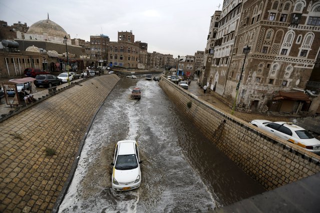 Cars drive in floodwaters during a rainy day in the old quarter of Yemen's capital Sanaa August 1, 2015. (Photo by Khaled Abdullah/Reuters)
