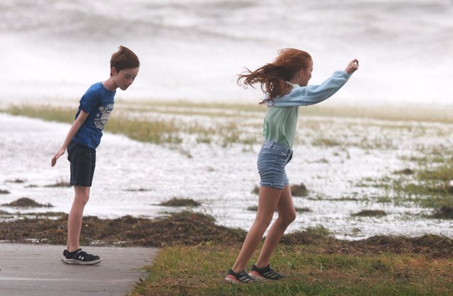 Quinn O'Hogan (L) and Kendall O'Hogan lean into the winds from Hurricane Helene as it passes offshore on September 26, 2024, in St. Petersburg, Florida. Helene is forecast to become a major hurricane, bringing the potential for deadly storm surges, flooding rain, and destructive hurricane-force winds along parts of the Florida West Coast. (Photo by Joe Raedle/Getty Images)