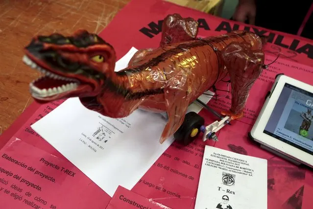 A dinosaur robot built with recycled materials is pictured during the annual robotics fair supported by the Bolivian Education Ministry in La Paz, August 10, 2015. The robot cost about $2 to make. (Photo by David Mercado/Reuters)