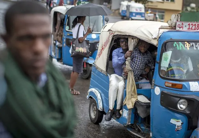 Passengers look out from an auto-rickshaw, known locally as a “bajaj”, in Gondar, in the Amhara region of Ethiopia on May 2, 2021. Once a key ally of the federal government in its deadly war in the Tigray region, the neighboring Amhara region has in May 2022 experienced government-led mass arrests and disappearances of activists, journalists and other perceived critics. (Photo by Ben Curtis/AP Photo/File)