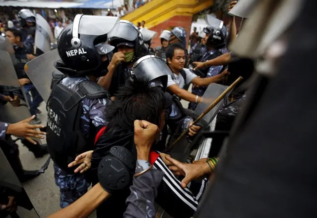 Police detain a protester (C) during a rally organised by a 30-party alliance led by a hardline faction of former Maoist rebels, who are protesting against the draft of the new constitution, in Kathmandu August 15, 2015. (Photo by Navesh Chitrakar/Reuters)