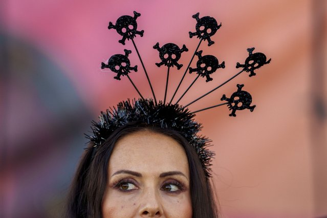 A woman attends the West Side Hallo Fest, a Halloween festival in Bucharest, Romania, Saturday, October 26, 2024. (Photo by Andreea Alexandru/AP Photo)