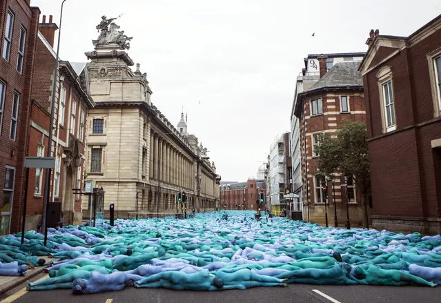 People take part in an art installation entitled Sea of Hull by New York based artist Spencer Tunick in Hull, England, Saturday July 9, 2016. (Photo by Danny Lawson/PA Wire via AP Photo) 