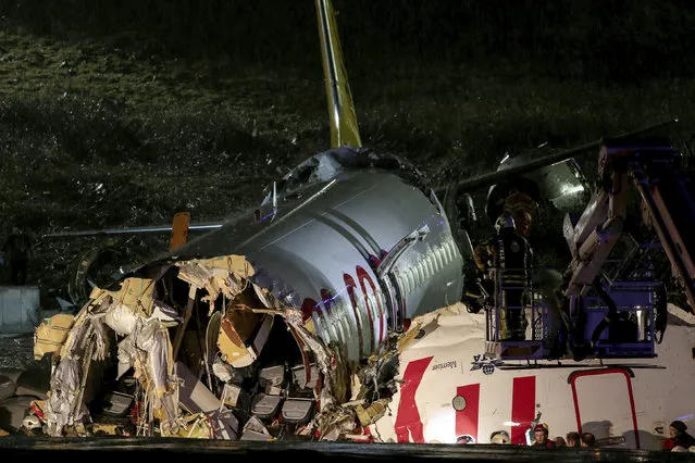 Rescue members and firefighters work after a plane skidded off the runway at Istanbul's Sabiha Gokcen Airport, Istanbul, Wednesday, February 5, 2020. A plane skidded off the runway Wednesday at Istanbul’s Sabiha Gokcen Airport, crashing into a field and breaking into pieces. Passengers were seen evacuating through cracks in the plane and authorities said dozens have been injured. (Photo by Can Erok/DHA via AP Photo)