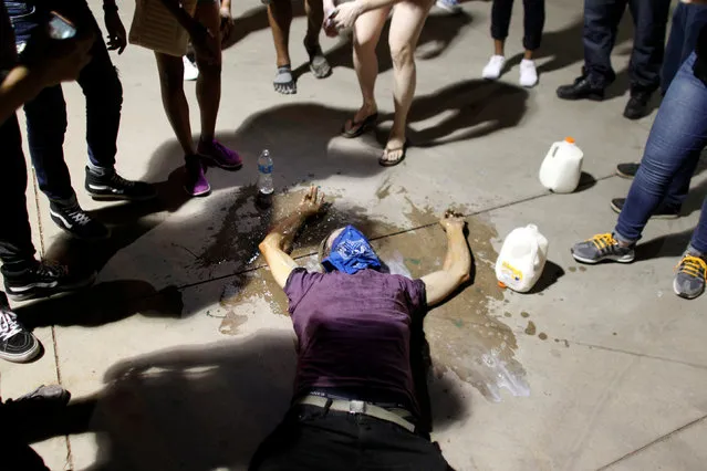 A protester is treated for exposure to pepper spray during a demonstration against fatal shootings by the police of two black men across the country, in Phoenix, Arizona, U.S. July 8, 2016. (Photo by Ricardo Arduengo/Reuters)