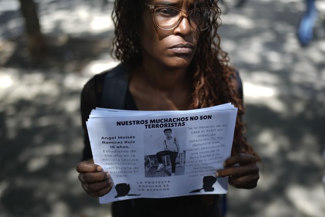 Marelys Ruiz holds an image of her detained 16-year-old nephew Angel Ramirez during a protest outside the Attorney General’s office, in Caracas, Venezuela, Thursday, September 26, 2024. Relatives of detained youths protested months after youths were arrested amid a government crackdown after anti-government protests against election results. (Photo by Ariana Cubillos/AP Photo)