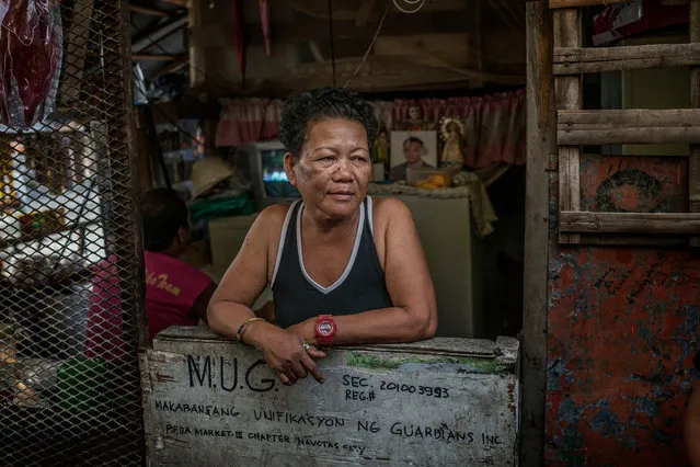 Rosita Opiasa, 59, in her home in Navotas’s Market 3 shanty town. Her son, Jayson Rivera, 32, was killed in the drugs war. She still supports Duterte, which is rare in Market 3. Rivera’s photograph can be seen in the background. Opiasa runs this corner shop, where she sells single cigarettes or various small bottles of shampoo and detergent because her customers can’t afford larger sizes. (Photo by James Whitlow Delano/Funded by the Pulitzer Center on Crisis Reporting/The Guardian)