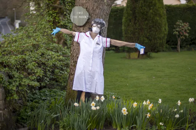 Residents display scarecrows with an NHS theme outside their homes in Greenfield for the annual scarecrow parade on April 09, 2020 in Manchester, United Kingdom. There have been around 60,000 reported cases of the COVID-19 coronavirus in the United Kingdom and 7,000 deaths. The country is in its third week of lockdown measures aimed at slowing the spread of the virus. (Photo by Anthony Devlin/Getty Images)