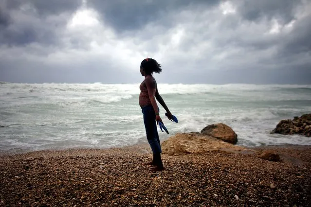 A woman looks out at the sea as Tropical Storm Isaac approaches Barahona, Dominican Republic August 24, 2012. The storm's failure to gain the kind of strength in the Caribbean that forecasters initially projected made it more likely that Isaac won't become a hurricane until it enters the Gulf of Mexico, said Eric Blake, a forecaster with U.S. National Hurricane Center in Miami. (Photo by Ricardo Arduengo/Associated Press)