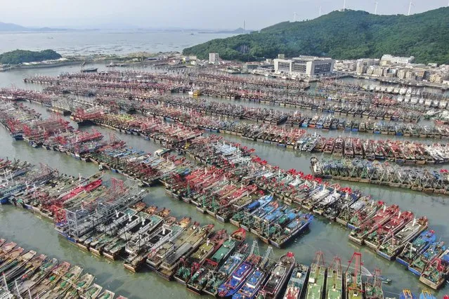 Fishing boats return to port for shelter before the arrival of tropical storm Ma-on in southern China’s Guangdong province on August 24, 2022. The storm has already displaced thousands in the Philippines. (Photo by Deng Hua/AP Photo)