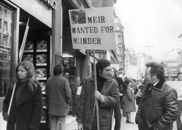 Peter Hain,  leader of Young Liberals,  heads a demo in a street outside El Al office holding poster (Golda) “Meir Wanted For Murder” after Israeli forces shot down a Libyan airliner. 22nd February 1973. (Photo by Michael Webb/Keystone)