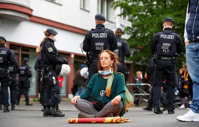 A woman meditates during a left-wing May Day demonstration, as the spread of the coronavirus disease (COVID-19) continues, in Berlin, Germany on May 1, 2020. (Photo by Hannibal Hanschke/Reuters)