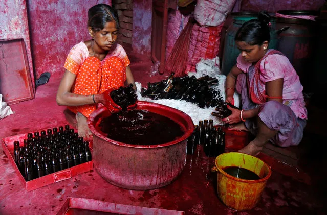 Workers fill bottles with Alta, a red dye which Hindu women apply with cotton on the border of their feet during marriages and religious festivals, at a workshop in Kolkata, India August 2, 2016. (Photo by Rupak De Chowdhuri/Reuters)