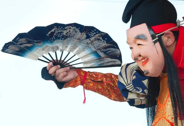 A Japanese performs as god Ebisu during a Kagura trance dance performance by local teenagers in Gotsu city, Shimane prefecture, 07 August 2016. The Iwami Kagura, found in Shimane prefecture, is considered one of the three major forms of Kagura trance dance in Japan. The dance originated in ancient Japanese mythology and was performed to entertain the Japanese Shinto gods of nature. (Photo by Everett Kennedy Brown/EPA)