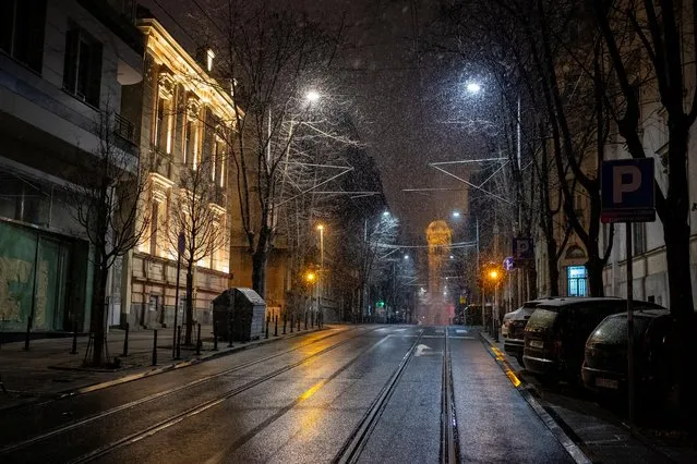 Snow falls at empty Resavska street during a curfew imposed to prevent the spread of coronavirus disease (COVID-19) in Belgrade, Serbia, March 23, 2020. (Photo by Marko Djurica/Reuters)