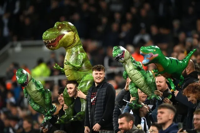 Fans of Newcastle United carry T-Rex inflatables to taunt Jordan Pickford of Everton during the Premier League match between Newcastle United and Everton FC at St. James Park on October 19, 2022 in Newcastle upon Tyne, England. (Photo by Stu Forster/Getty Images)