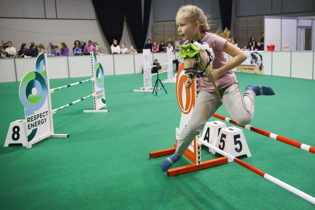 A competitor jumps while taking part in Hobby Horse competition during Cavaliada Tour, the largest series of indoor equestrian competitions in Poland, held at TAURON Arena venue in Krakow, on February 23rd, 2025. (Photo by Beata Zawrzel/NurPhoto/Rex Features/Shutterstock)