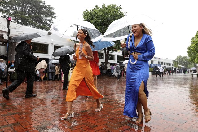 Racegoers brave the rain during 2022 Melbourne Cup Day at Flemington Racecourse on November 1, 2022 in Melbourne, Australia. (Photo by Martin Keep/Getty Images for VRC)
