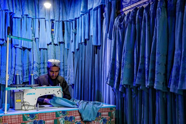 An Afghan tailor sews burqas for women, at a shop in Herat on February 18, 2025. (Photo by Mohsen Karimi/AFP Photo)