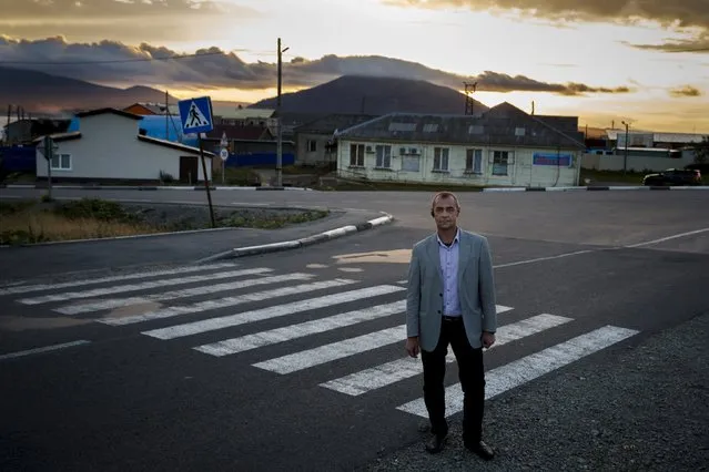 Director of the House of Russian-Japanese Friendship, Alexander Vygovsky, poses for a picture on a street in Yuzhno-Kurilsk, the main settlement on the Southern Kurile island of Kunashir September 15, 2015. (Photo by Thomas Peter/Reuters)