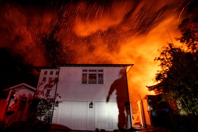 The wind whips embers as the Palisades fire burns during a windstorm on the west side of Los Angeles on January 9, 2025. (Photo by Ringo Chiu/Reuters)