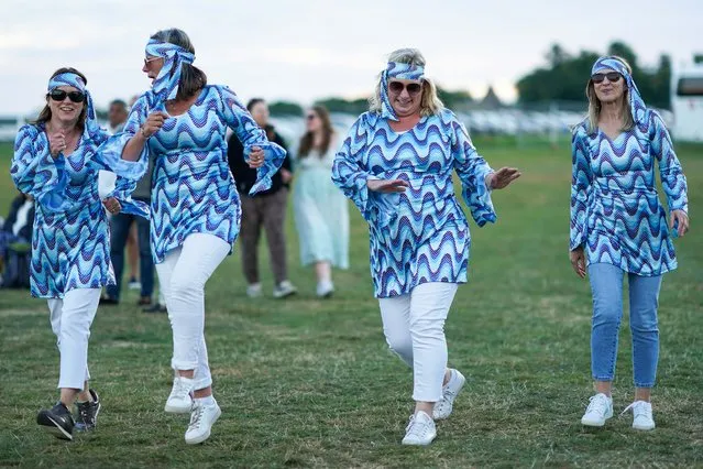 A group of friends dance during ABBA: A Symphonic Spectacular at Castle Howard on August 21, 2022 in York, England. Forming part of the Castle Howard Live Music Weekend 2022, the performance celebrates the greatest hits of ABBA featuring star performers from “Mamma Mia”, a full rock band and the Heart of England Orchestra. (Photo by Ian Forsyth/Getty Images)