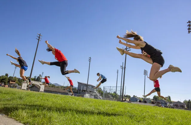 Moscow High School students practice a cheerleading routine on Monday, August 10, 2020, in Moscow, Idaho. Idaho schools are moving forward with plans to hold fall sports, but with precautions in place to help prevent the spread of the coronavirus. (Photo by Geoff Crimmins/The Moscow-Pullman Daily News via AP Photo)
