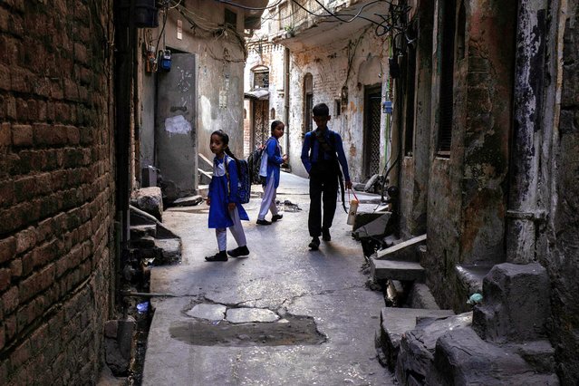 Students walk through an alley in the Shan Chan Chiragh neighborhood on their way to school in Rawalpindi, Pakistan on May 20, 2025. (Photo by Adrees Latif/Reuters)